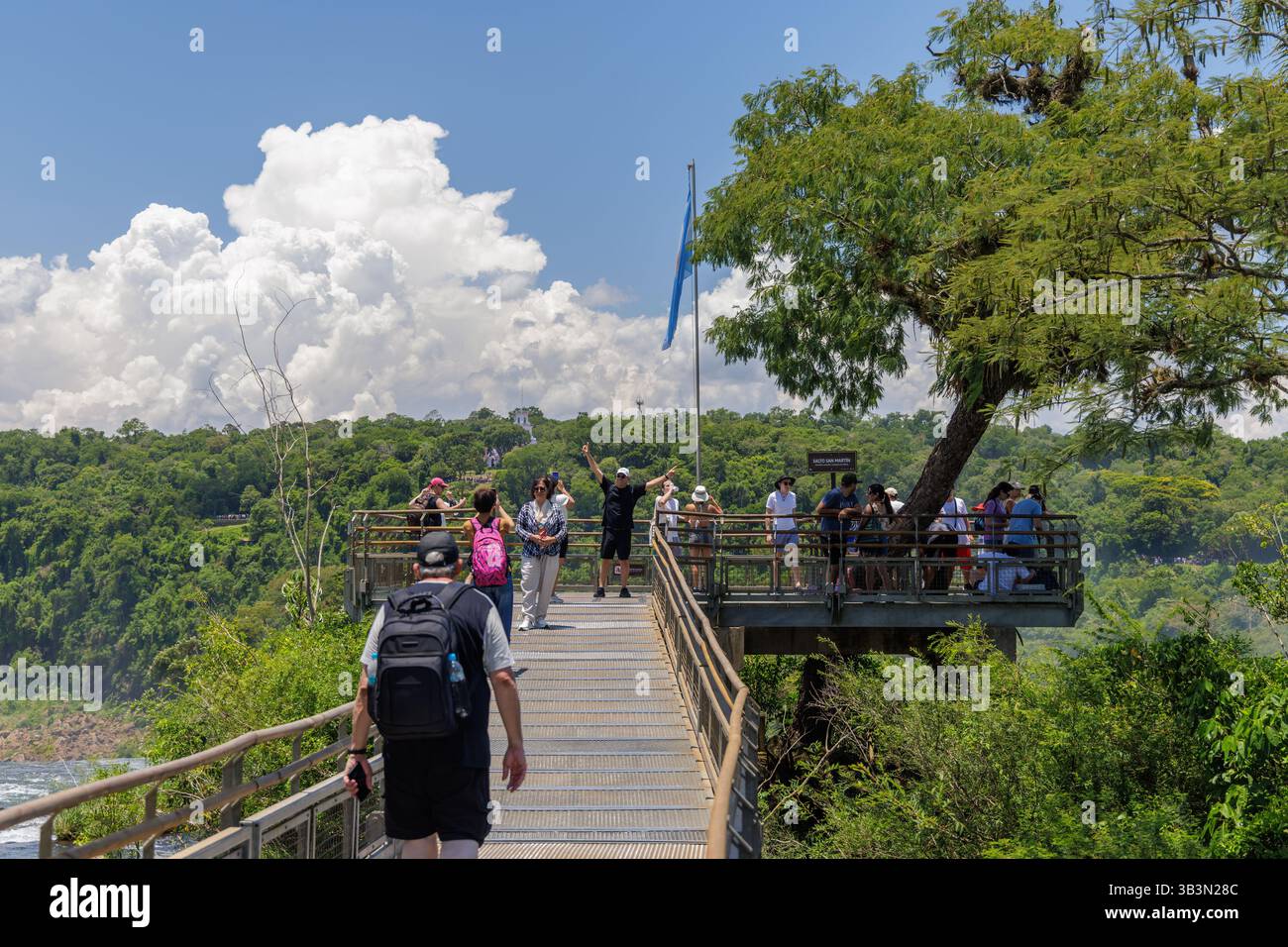 Puerto Iguazu, Misiones, Argentina - April 5th, 2025: Tourists trucking along the Iguazu National Park walkways. Stock Photo