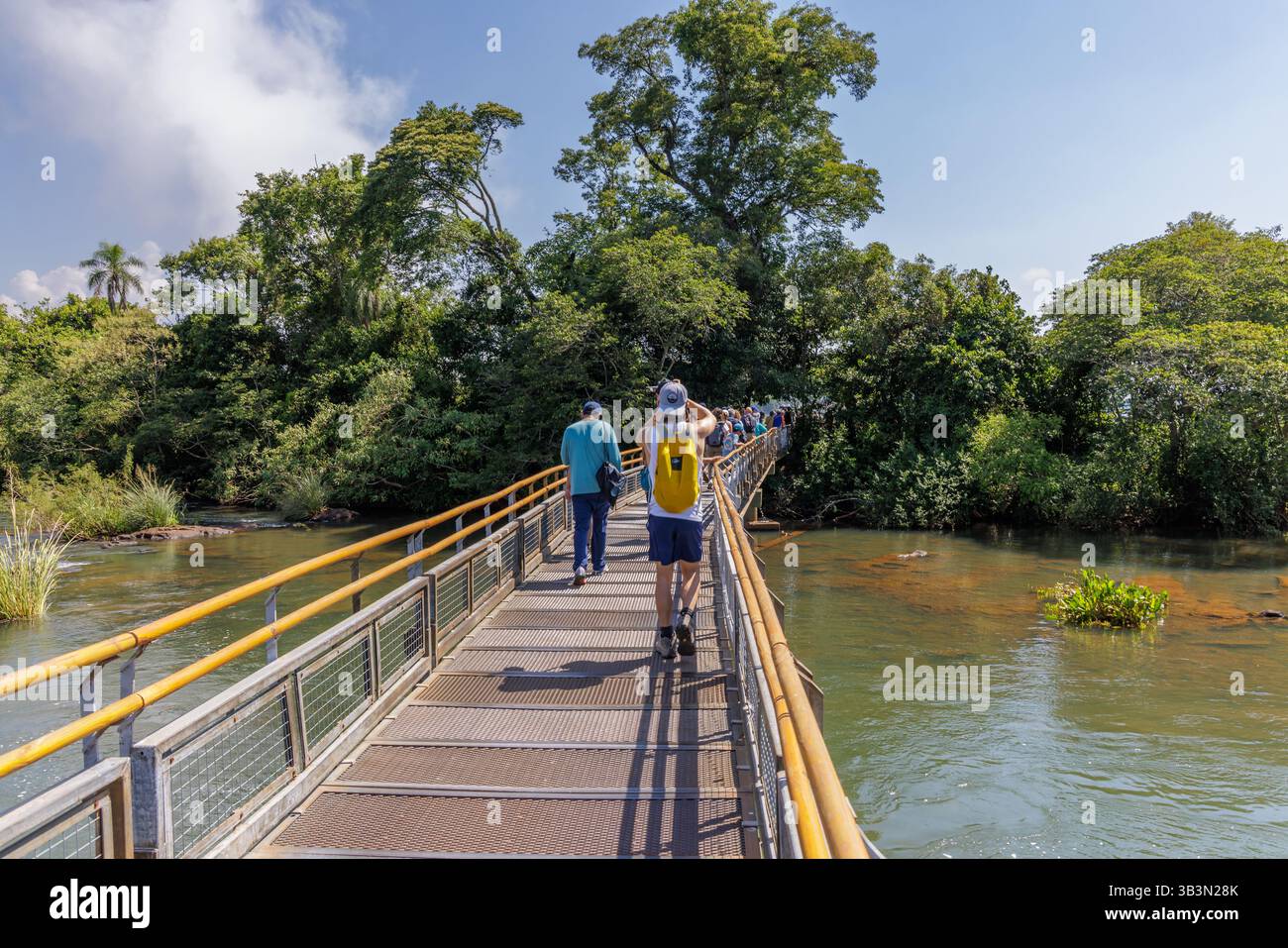 Puerto Iguazu, Misiones, Argentina - April 5th, 2025: Tourists trucking along the Iguazu Falls walkways. Stock Photo