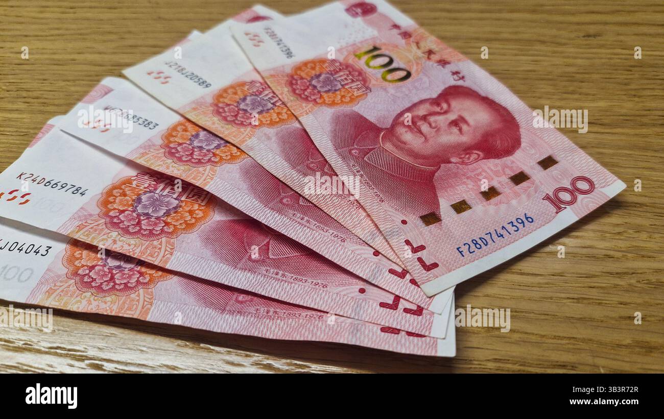 Chinese Yuan renminbi banknotes, paper money, Bank of China currency. Chinese financial system. Income and payments concept. - Smartphone Captured Stock Image
