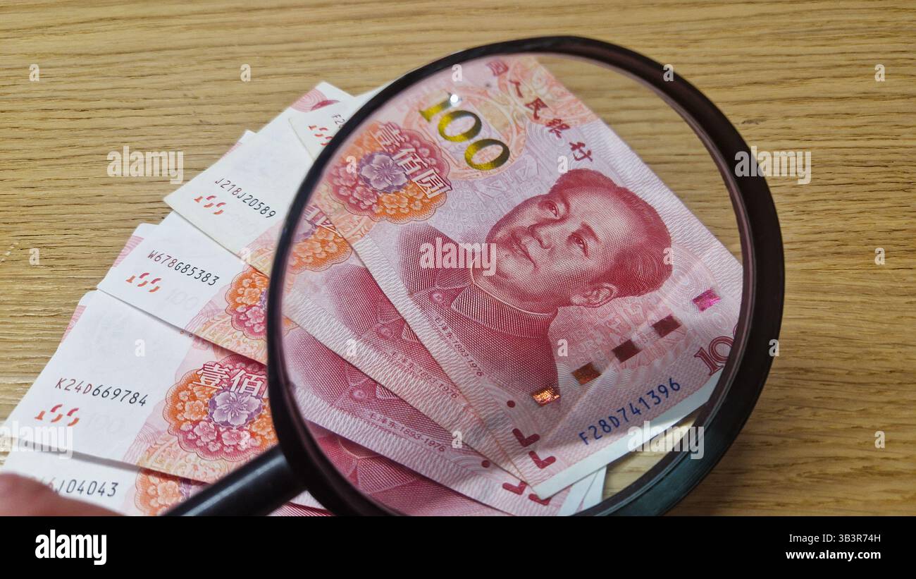 Chinese Yuan renminbi banknotes, paper money, Bank of China currency. Chinese financial system. Income and payments concept. - Smartphone Captured Stock Image