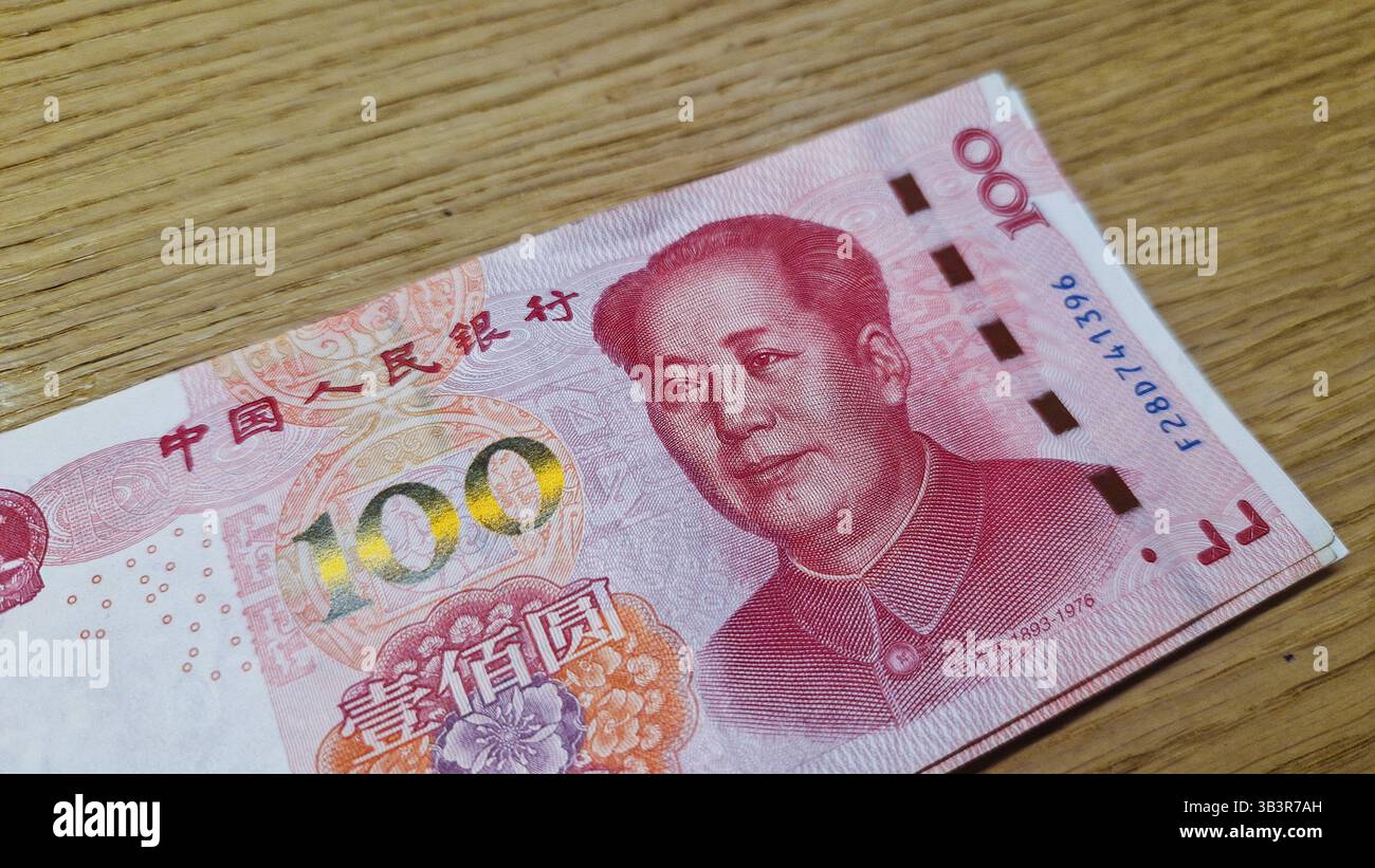Chinese Yuan renminbi banknotes, paper money, Bank of China currency. Chinese financial system. Income and payments concept. - Smartphone Captured Stock Image