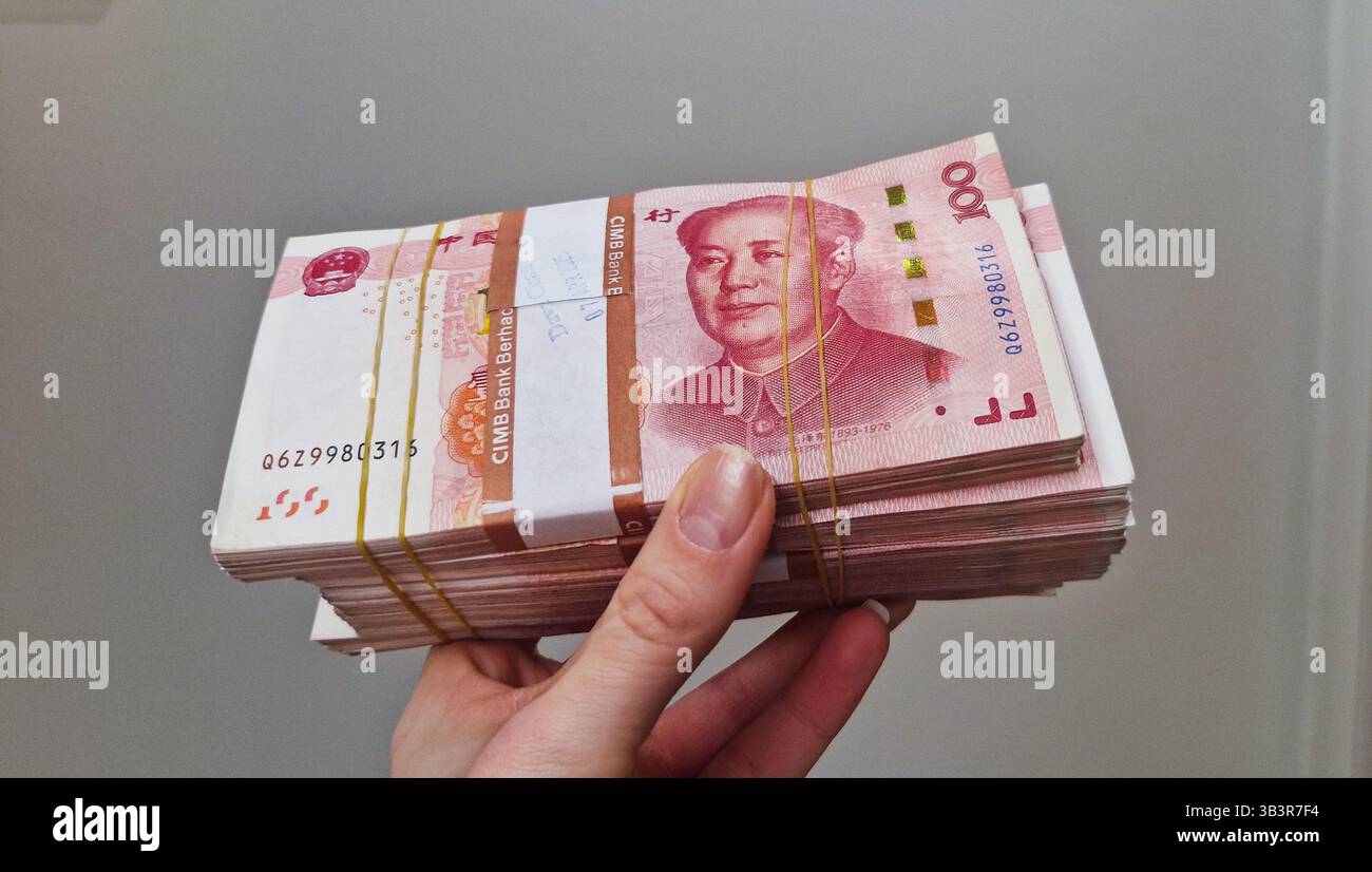 Chinese Yuan renminbi banknotes, paper money, Bank of China currency. Chinese financial system. Income and payments concept. - Smartphone Captured Stock Image