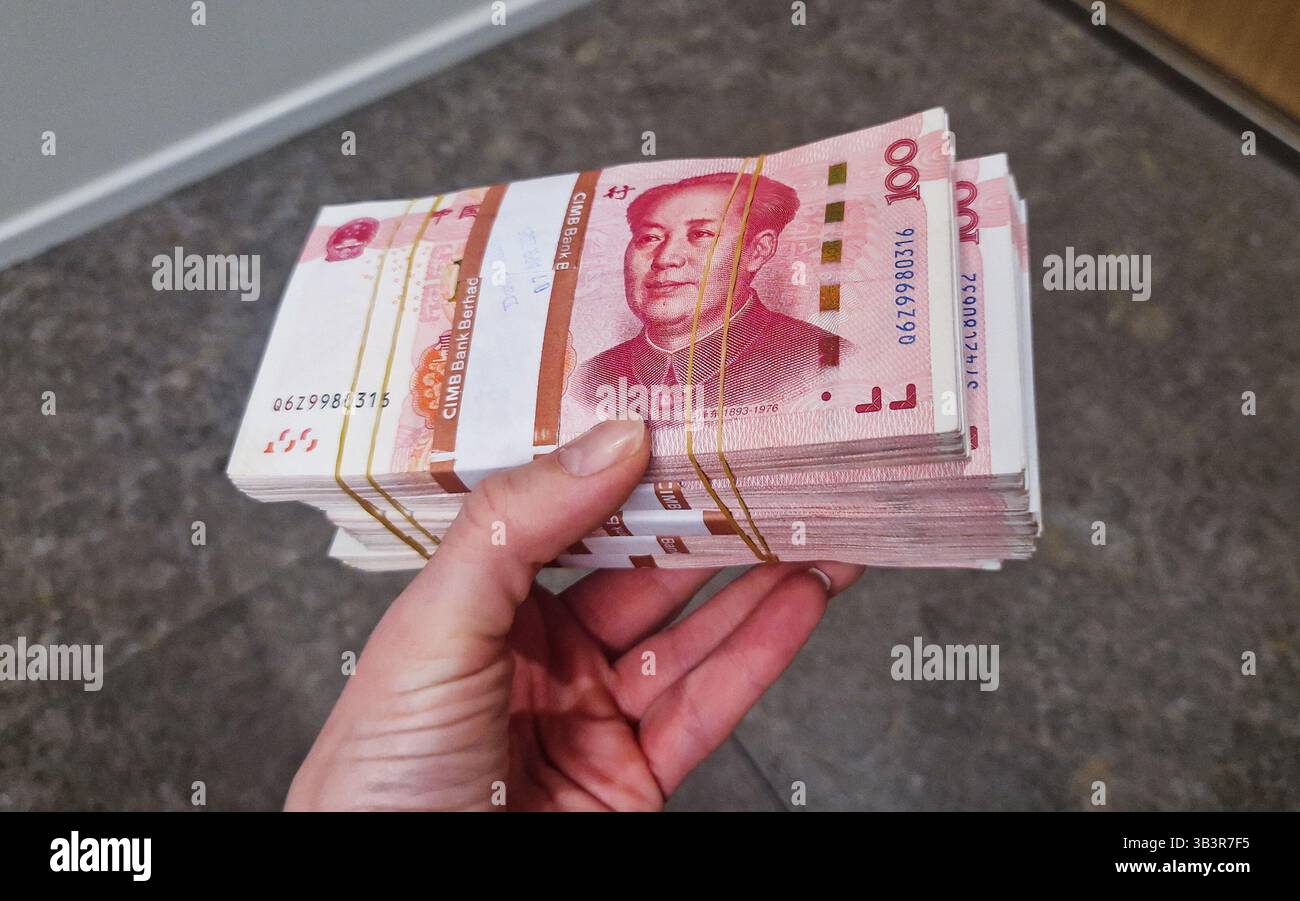 Chinese Yuan renminbi banknotes, paper money, Bank of China currency. Chinese financial system. Income and payments concept. - Smartphone Captured Stock Image