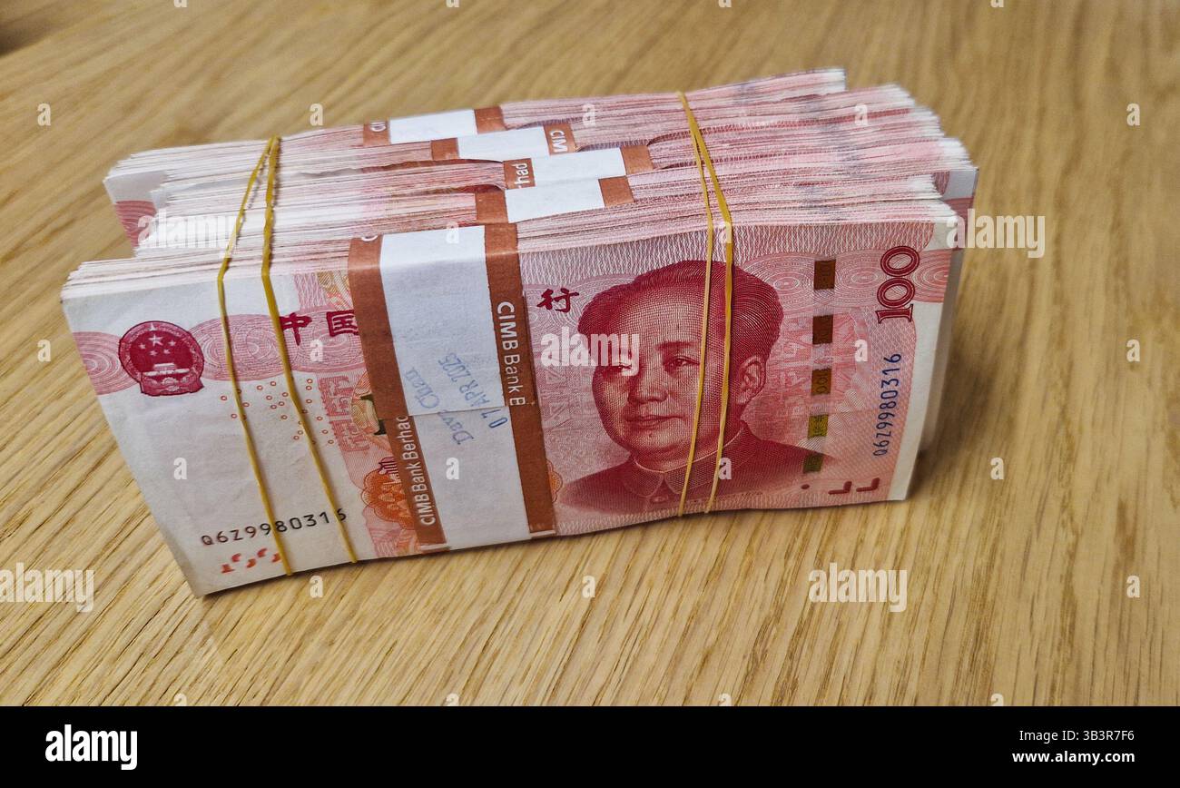 Chinese Yuan renminbi banknotes, paper money, Bank of China currency. Chinese financial system. Income and payments concept. - Smartphone Captured Stock Image