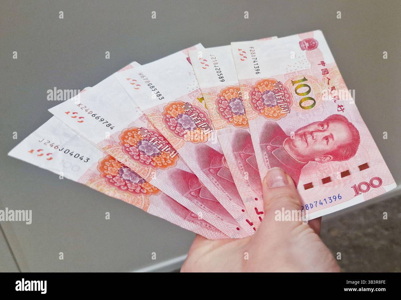 Chinese Yuan renminbi banknotes, paper money, Bank of China currency. Chinese financial system. Income and payments concept. - Smartphone Captured Stock Image