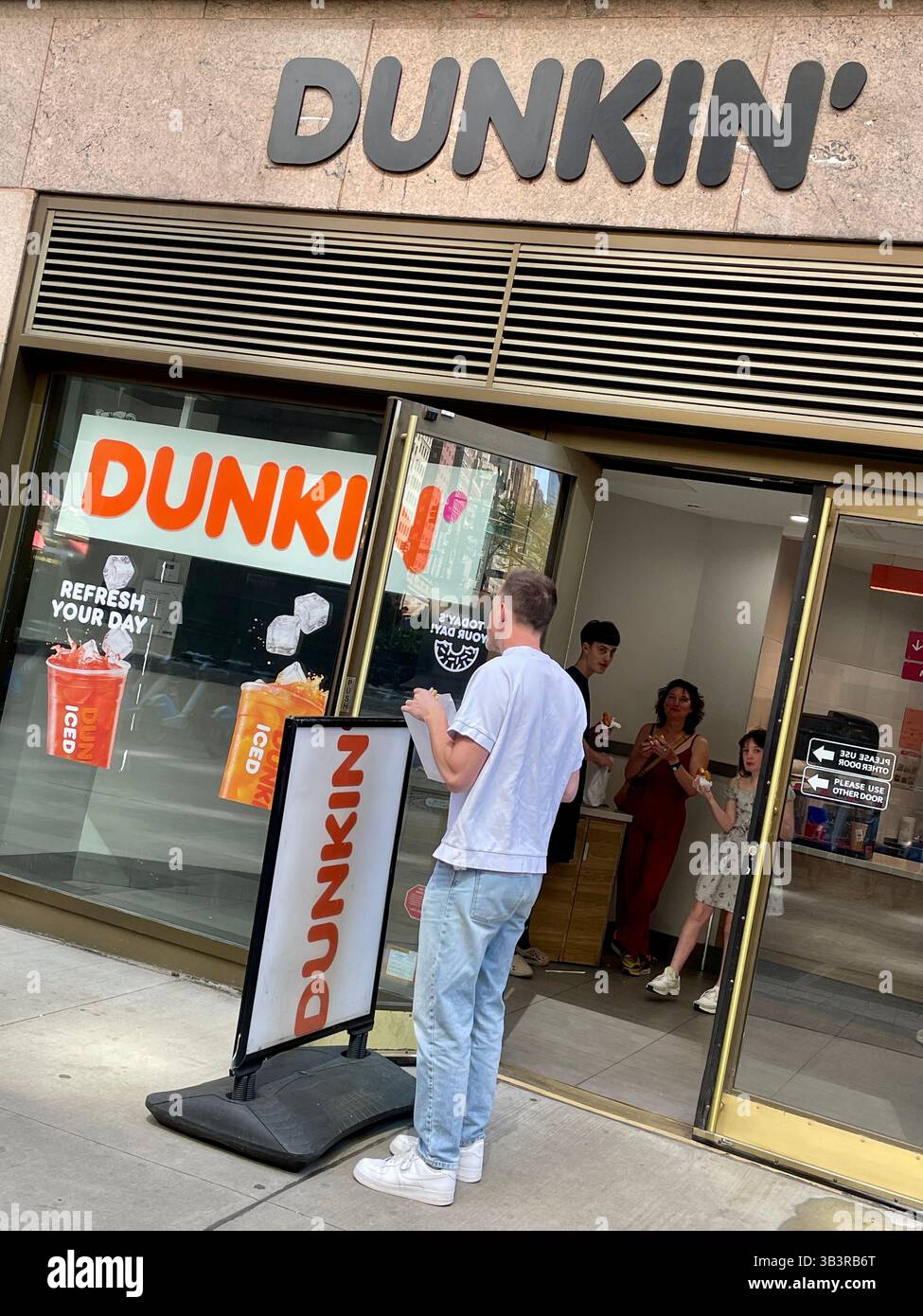 Dunkin Donuts Coffeehouse Restaurant, Front Entrance Exterior in Pershing Square, NYC, 2025, USA - Smartphone Captured Stock Image