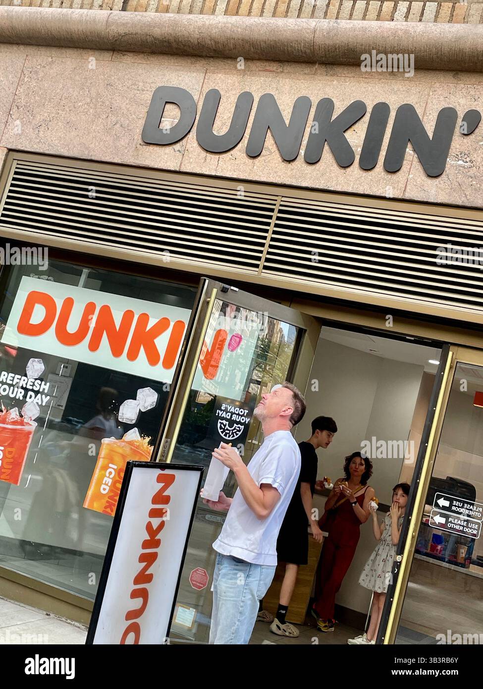 Dunkin Donuts Coffeehouse Restaurant, Front Entrance Exterior in Pershing Square, NYC, 2025, USA - Smartphone Captured Stock Image