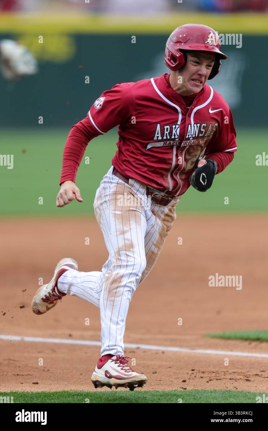 March 19, 2025: Razorback base runner Charles Davalan (24) rounds third ...