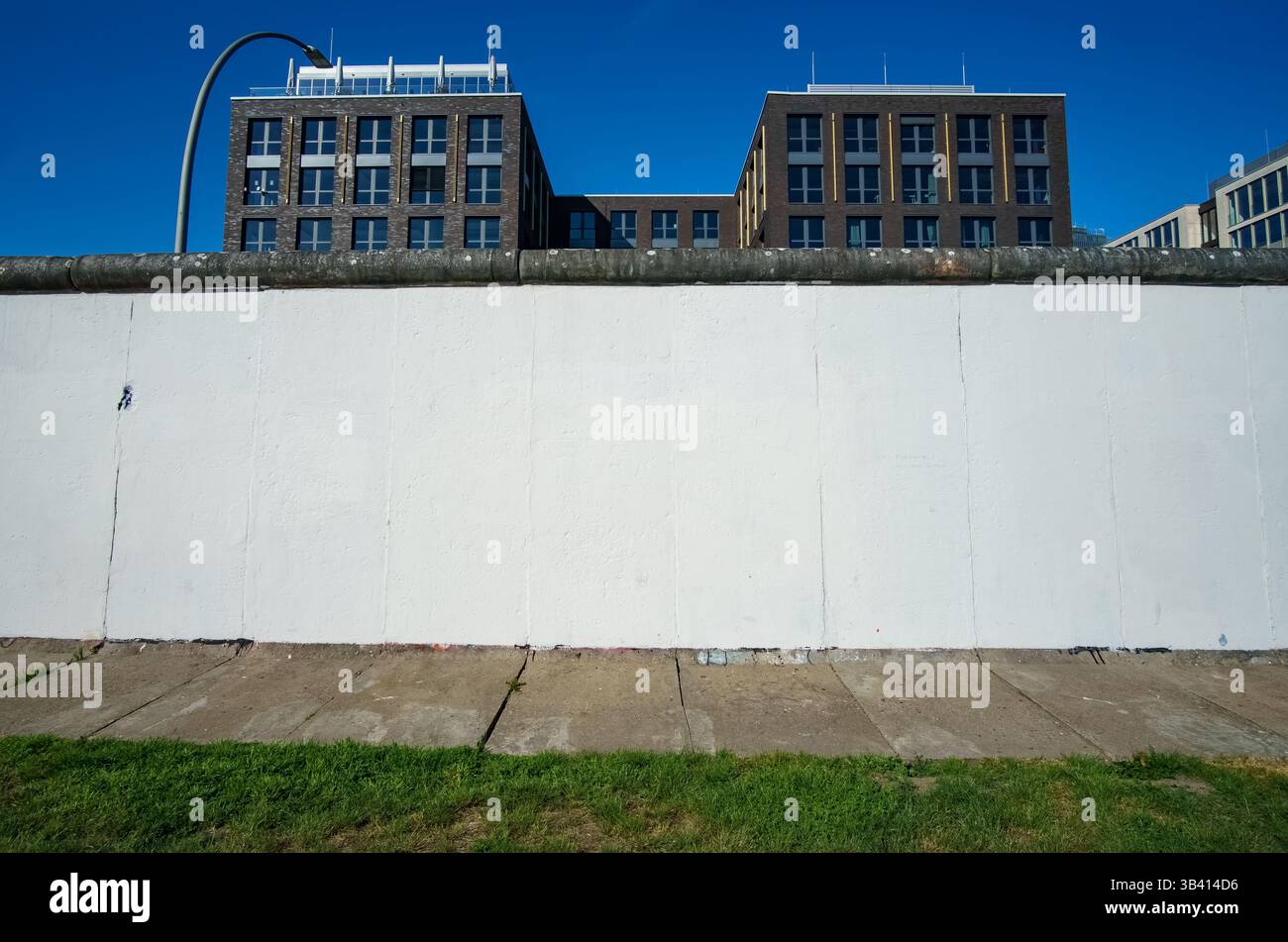 Freshly primed white Berlin Wall section at the East Side Gallery, awaiting new artwork in Berlin’s historic open-air gallery. Stock Photo
