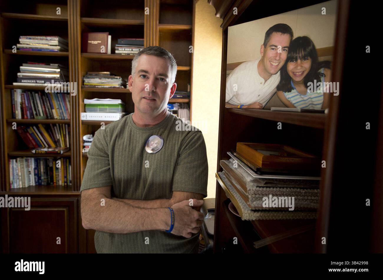 July 9, 2015 - Euless, TX, USA - Steve Roberts is seen at his home in Euless, Texas, with pictures of his daughter Kelsey on Thursday, July 9, 2015. Roberts is a volunteer for the Compassionate Friends conference for grieving parents and families in the death of children. His daughter, Kelsey, 11, was smothered by her mother at their home on Aug. 5, 2005. (Credit Image: © Joyce Marshall/TNS/ZUMA Wire) Stock Photo