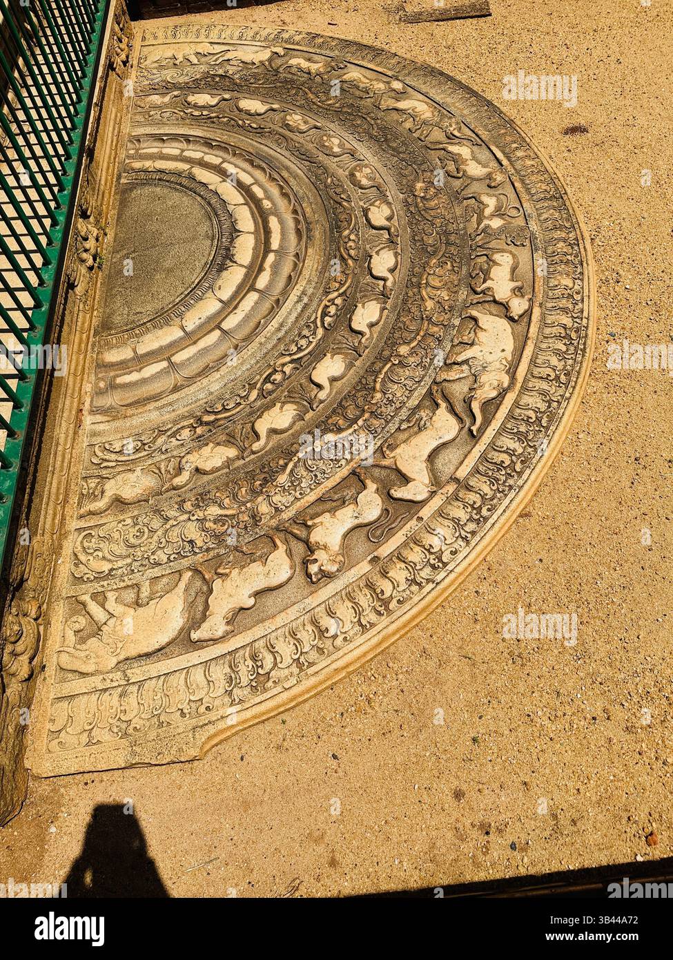 Intricately carved Sandakadapahana (moonstone) at a Sri Lankan ancient temple, symbolizing Buddhist art, culture, and spiritual heritage. - Smartphone Captured Stock Image