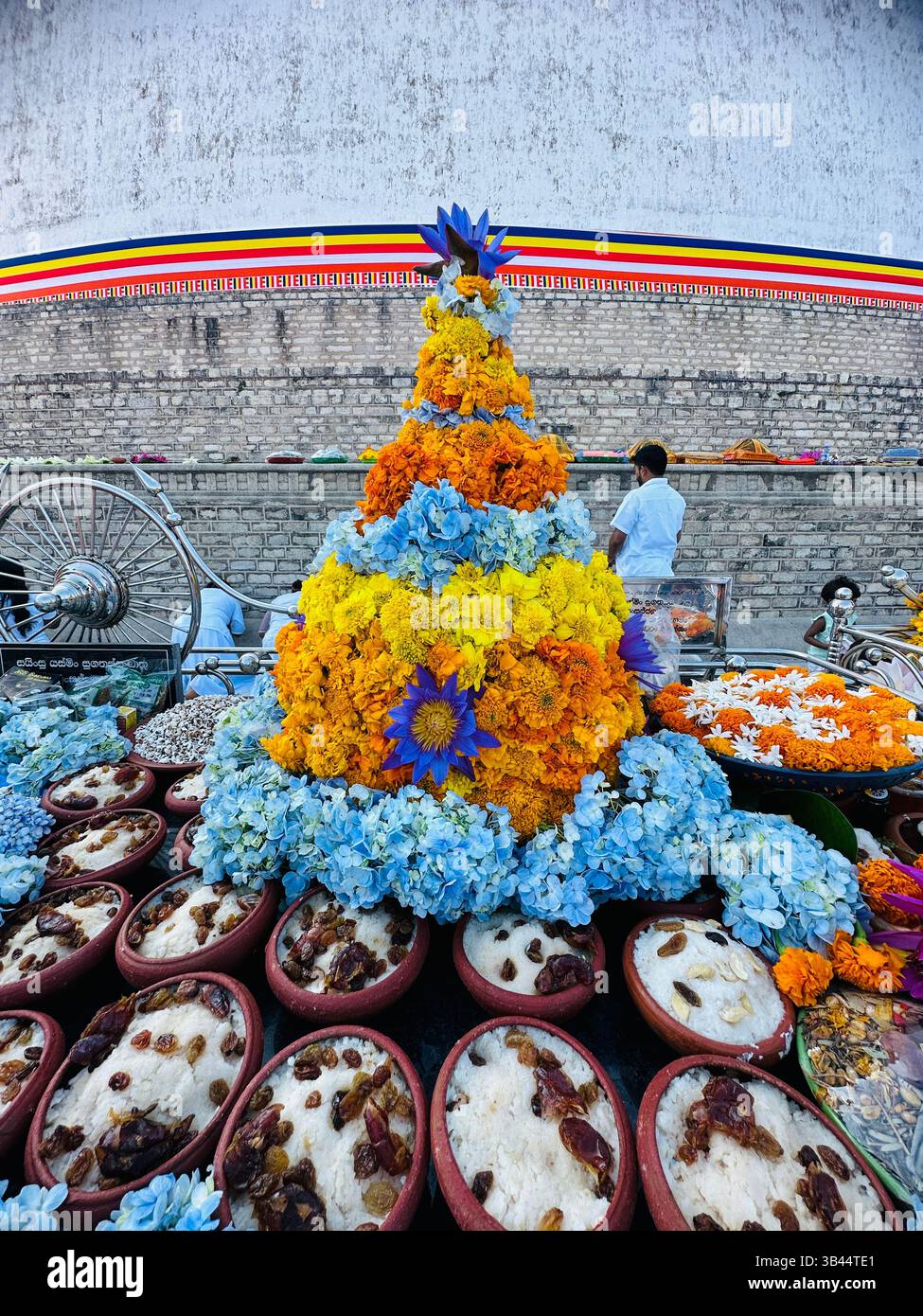 A beautiful moment at Ruwanwelisaya, where devotees offer food in reverence, capturing the essence of Sri Lanka's rich cultural - Smartphone Captured Stock Image
