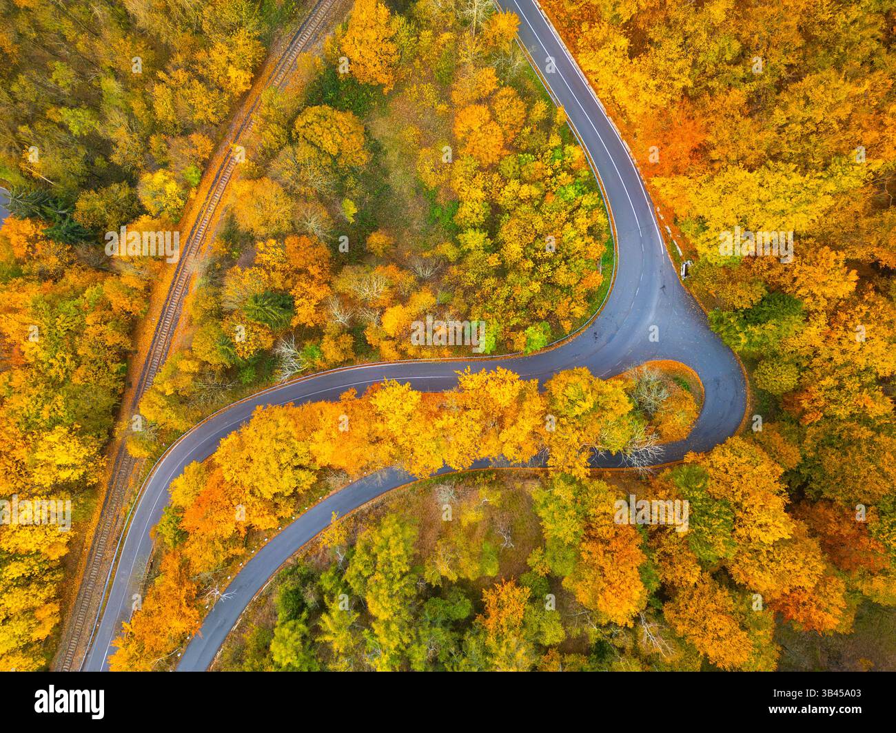 A picturesque winding road meanders through a breathtaking display of ...