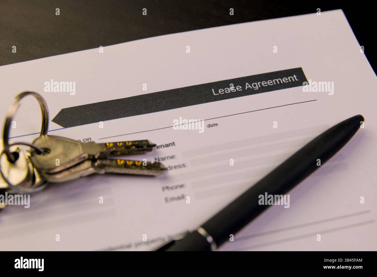 Close-up of lease agreement form with keys and pen illustrating rental ...