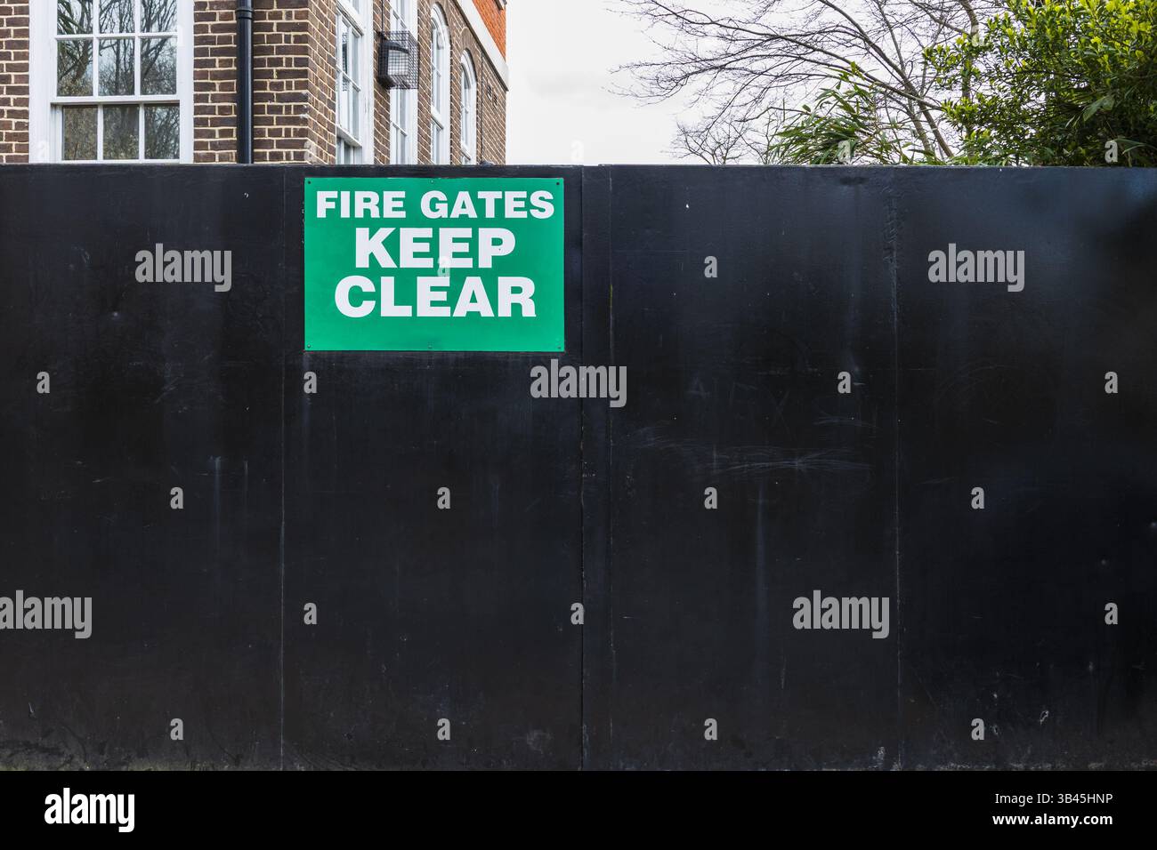 Fire Gates Keep Clear safety sign on black metal gate for emergency ...