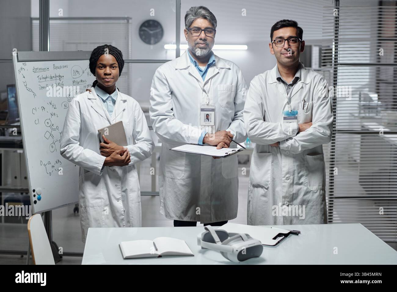Portrait of scientists standing together in modern lab environment ...