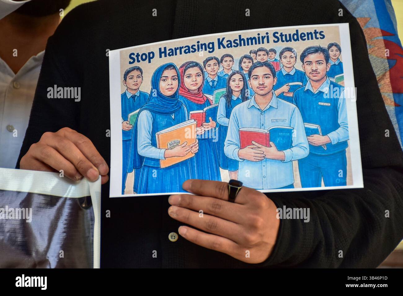 A Kashmiri student holds a placard during a protest following the ...
