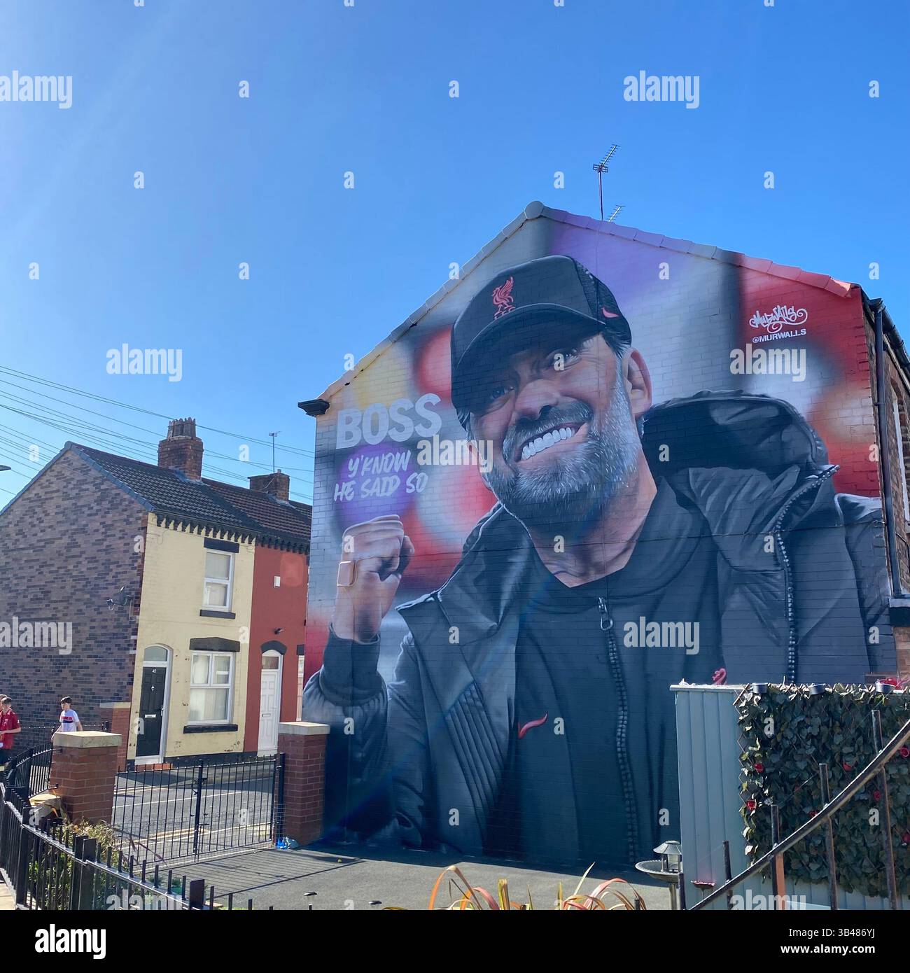 Mural of Liverpool manager Jurgen Klopp on a house near Anfield Stadium, Liverpool, England. Photographed 1 October 2022, clear blue sky. - Smartphone Captured Stock Image