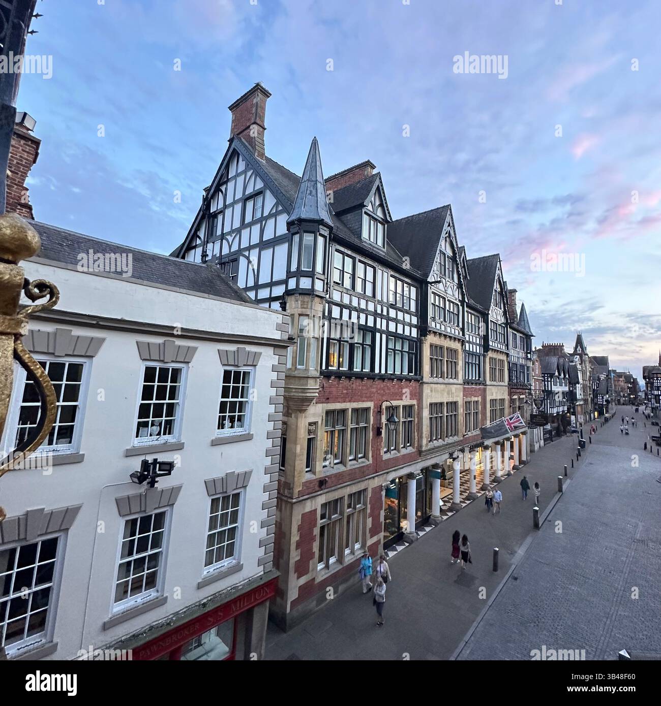 View from Eastgate Clock bridge looking west along Eastgate Street, Chester, with blue sky and scattered clouds. 29 July 2024. - Smartphone Captured Stock Image