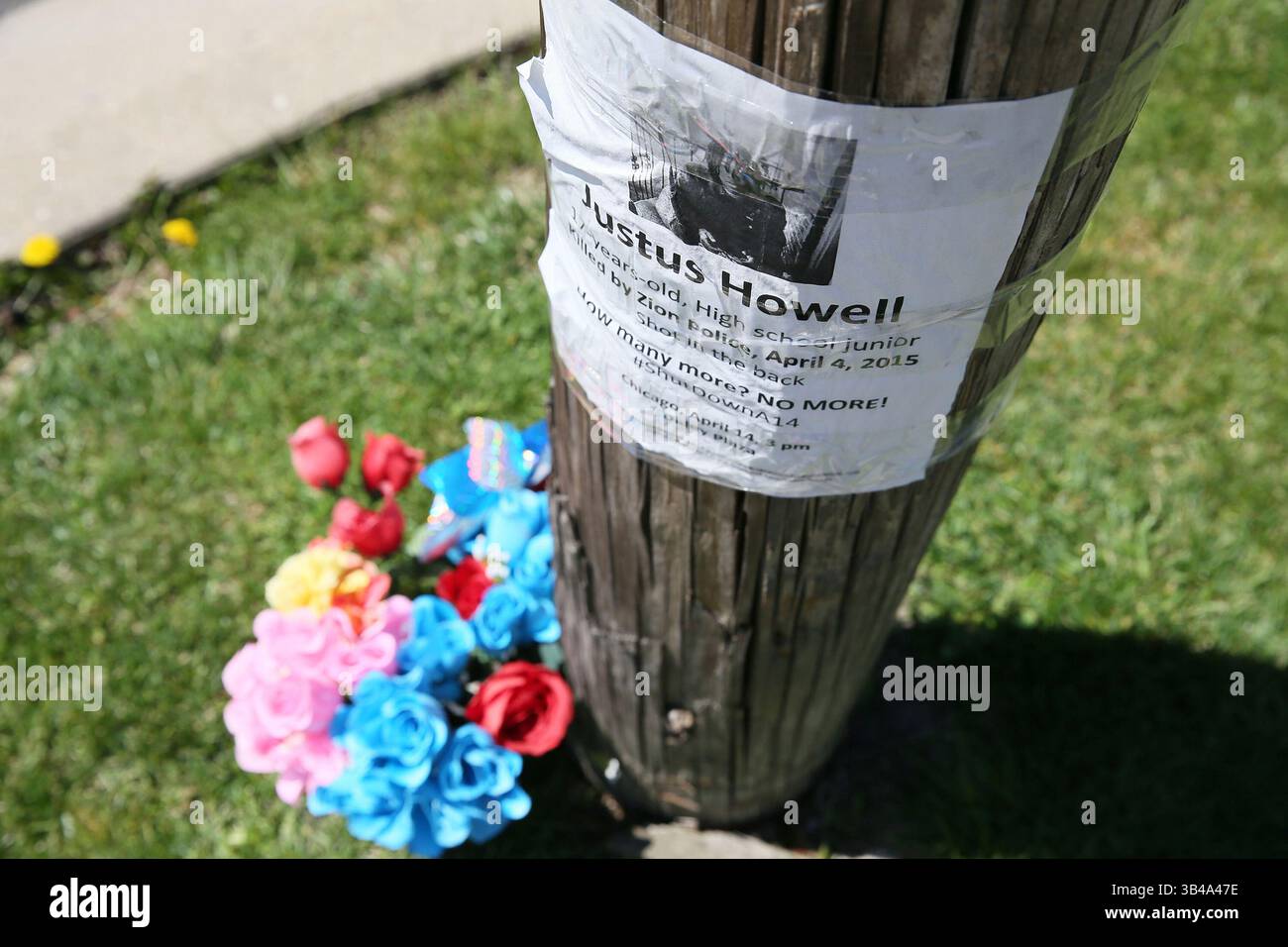 April 28, 2015 - Zion, IL, USA - A poster is taped to the telephone pole near the memorial for Justus Howell on the corner of 24th Street and Galilee Avenue in Zion, Ill., on Tuesday, April 28, 2015. Howell was shot in the back and killed by Zion police earlier this month. Today Lake County Coroner, Thomas Rudd released the autopsy report and ruled Howell's death a homicide. (Credit Image: © Stacey Wescott/TNS via ZUMA Wire) Stock Photo