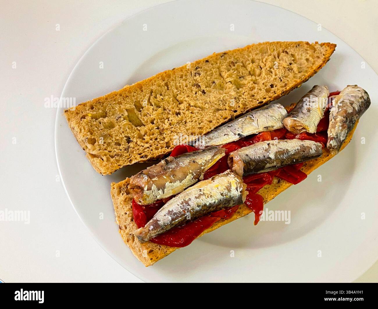 Red peppers and sardines on integral bread. - Smartphone Captured Stock Image