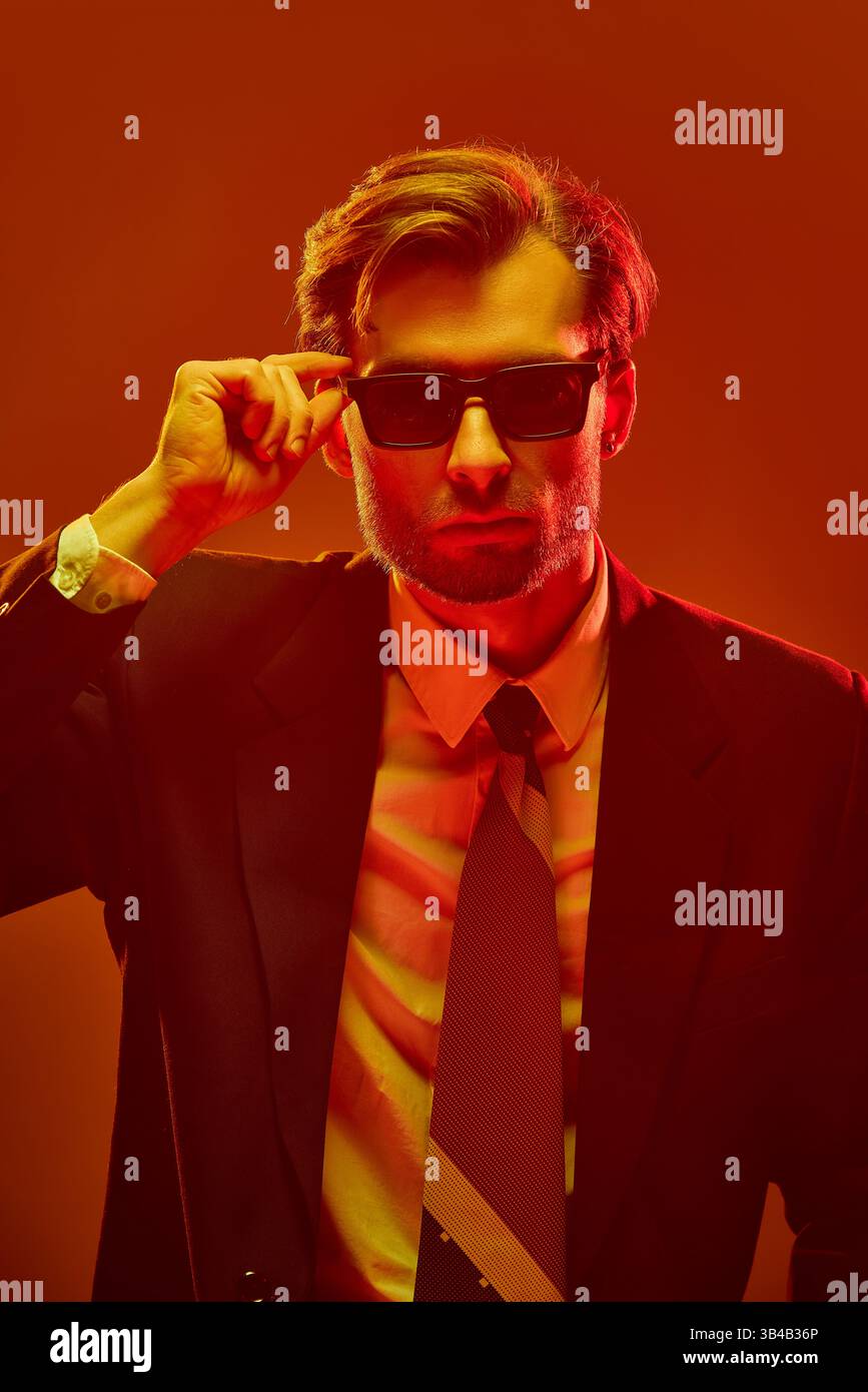 Close-up of young confident man lifting sunglasses with strong ...