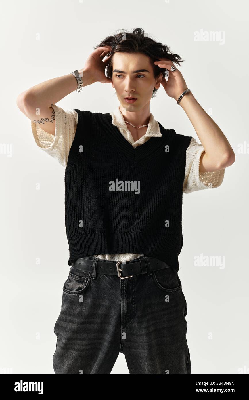 A handsome young man poses confidently in a trendy outfit against a ...