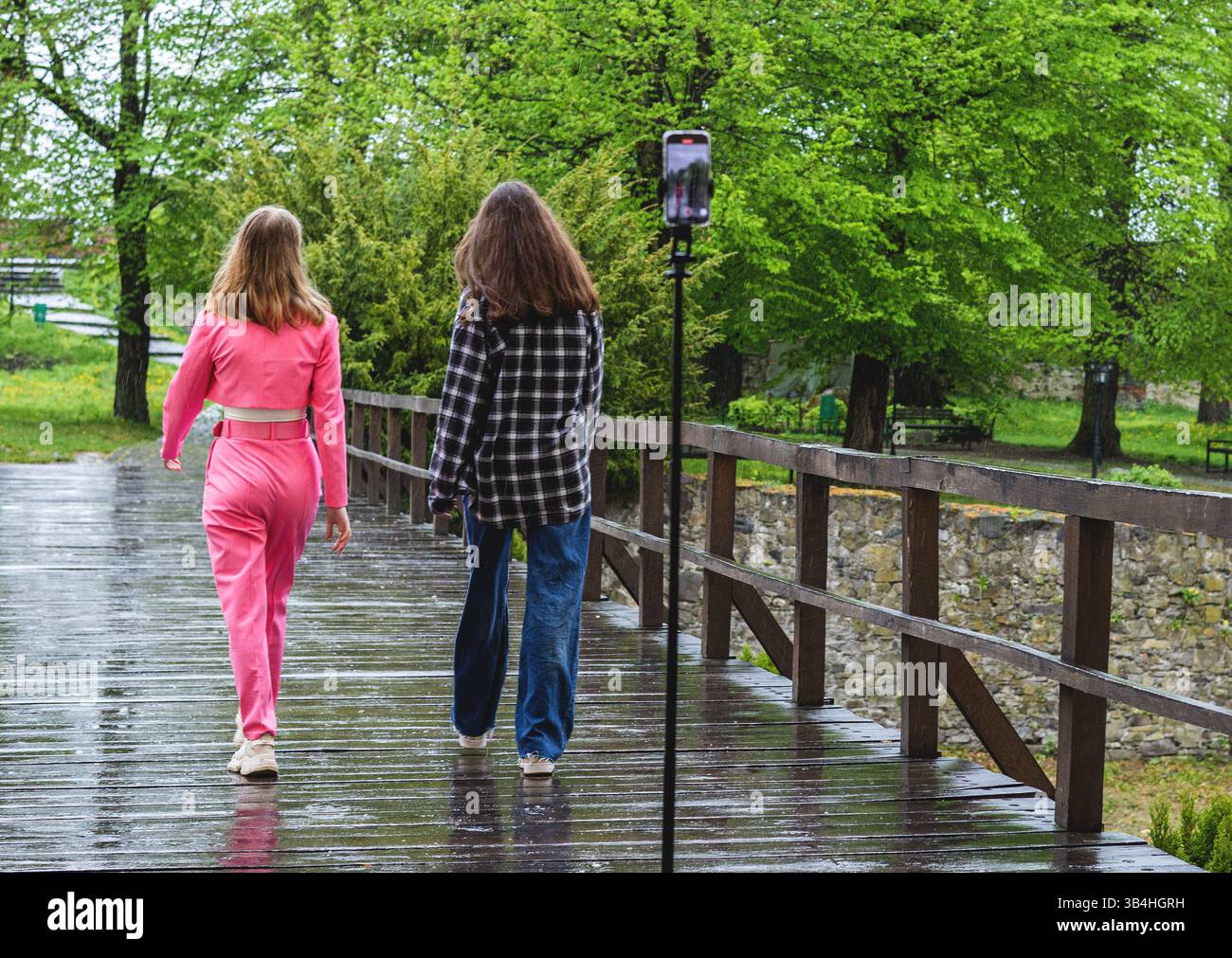 Two young bloggers shoot a video on a smartphone Stock Photo