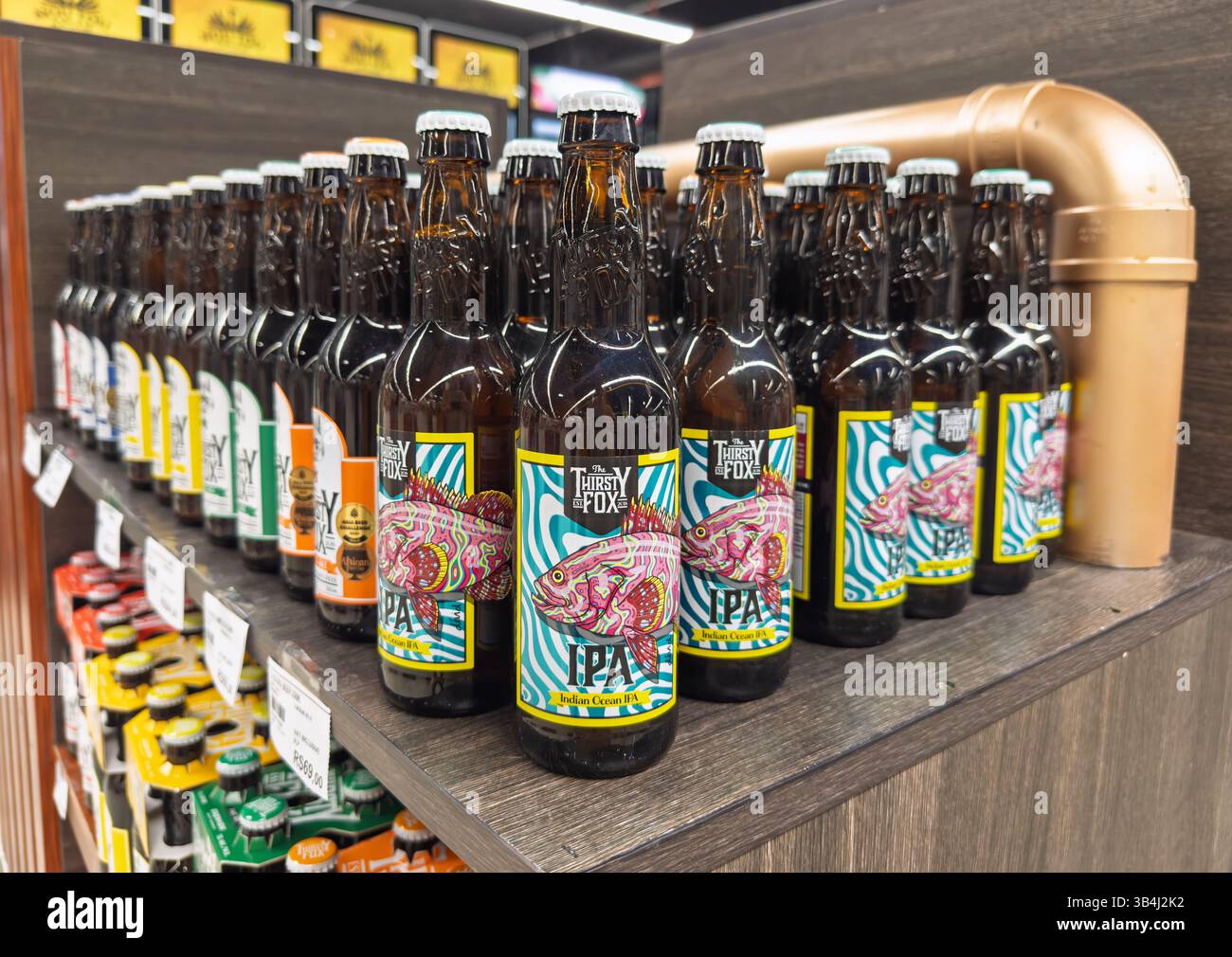 Grand Bay, Mauritius - January 29, 2025: Rows of The Thirsty Fox Indian Ocean IPA craft beer bottles displayed on a retail shelf. High quality photo Stock Photo