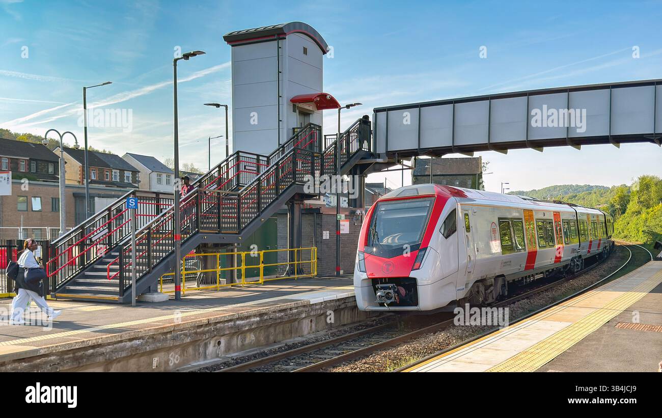 Treforest, Pontypridd, Wales, UK - 29 April 2025: Class 756 tri-mode commuter train leaving Treforest Railway station in evening sunlight. - Smartphone Captured Stock Image