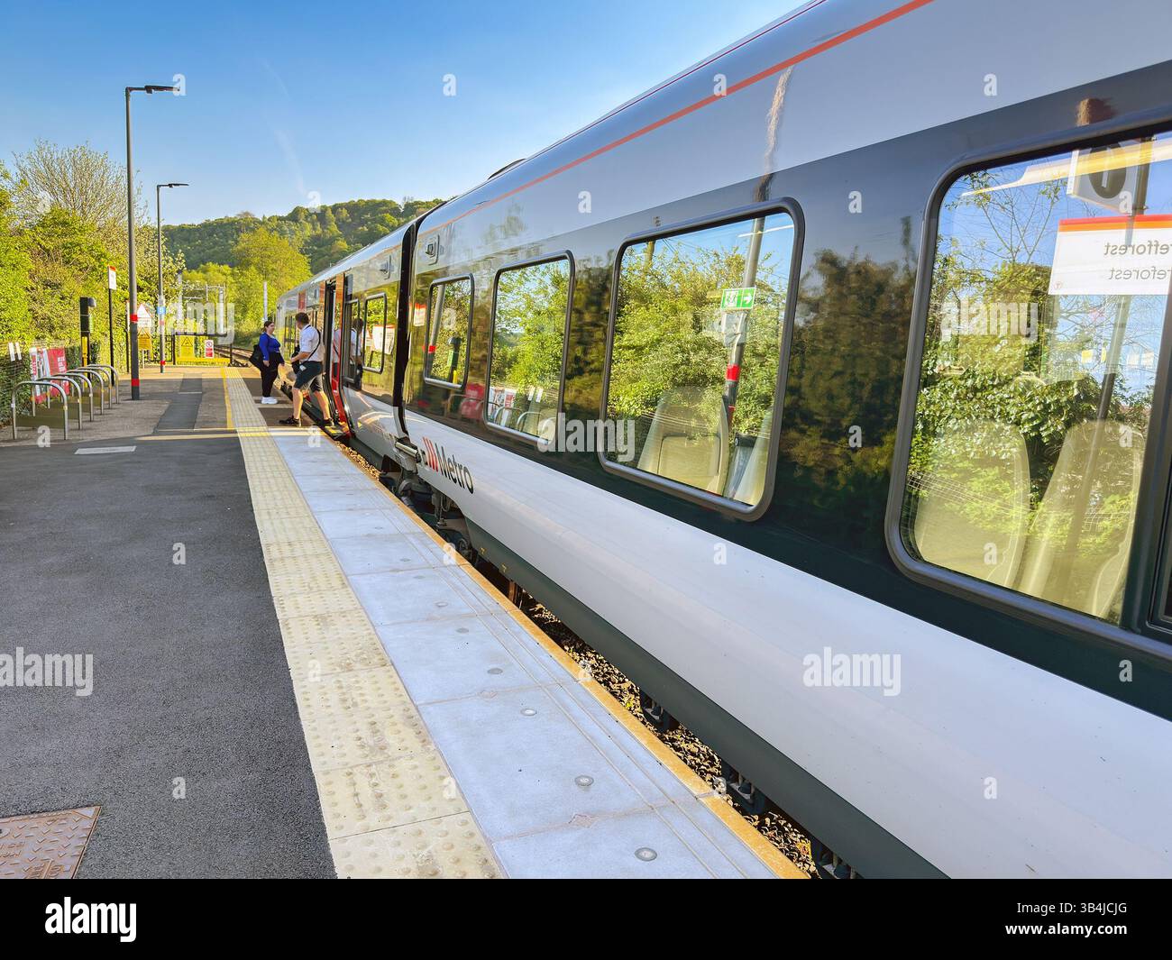 Treforest, Pontypridd, Wales, UK - 29 April 2025: people getting on and off a Class 756 tri-mode commuter train at Treforest Railway station - Smartphone Captured Stock Image
