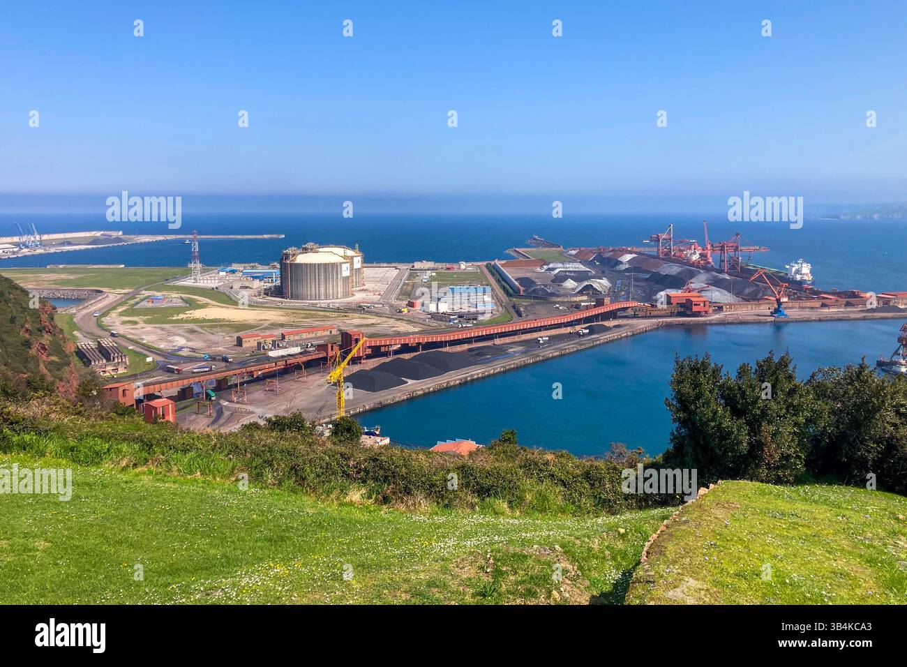 GIJON, SPAIN - APRIL  7, 2025: Gijón port settlements amidst scenic coastal landscapes in Gijón, Asturias, Spain - Smartphone Captured Stock Image