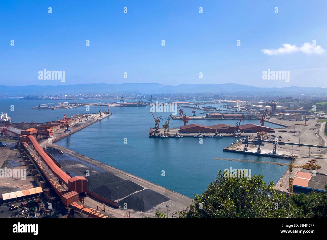 GIJON, SPAIN - APRIL  7, 2025: Gijón port settlements amidst scenic coastal landscapes in Gijón, Asturias, Spain - Smartphone Captured Stock Image