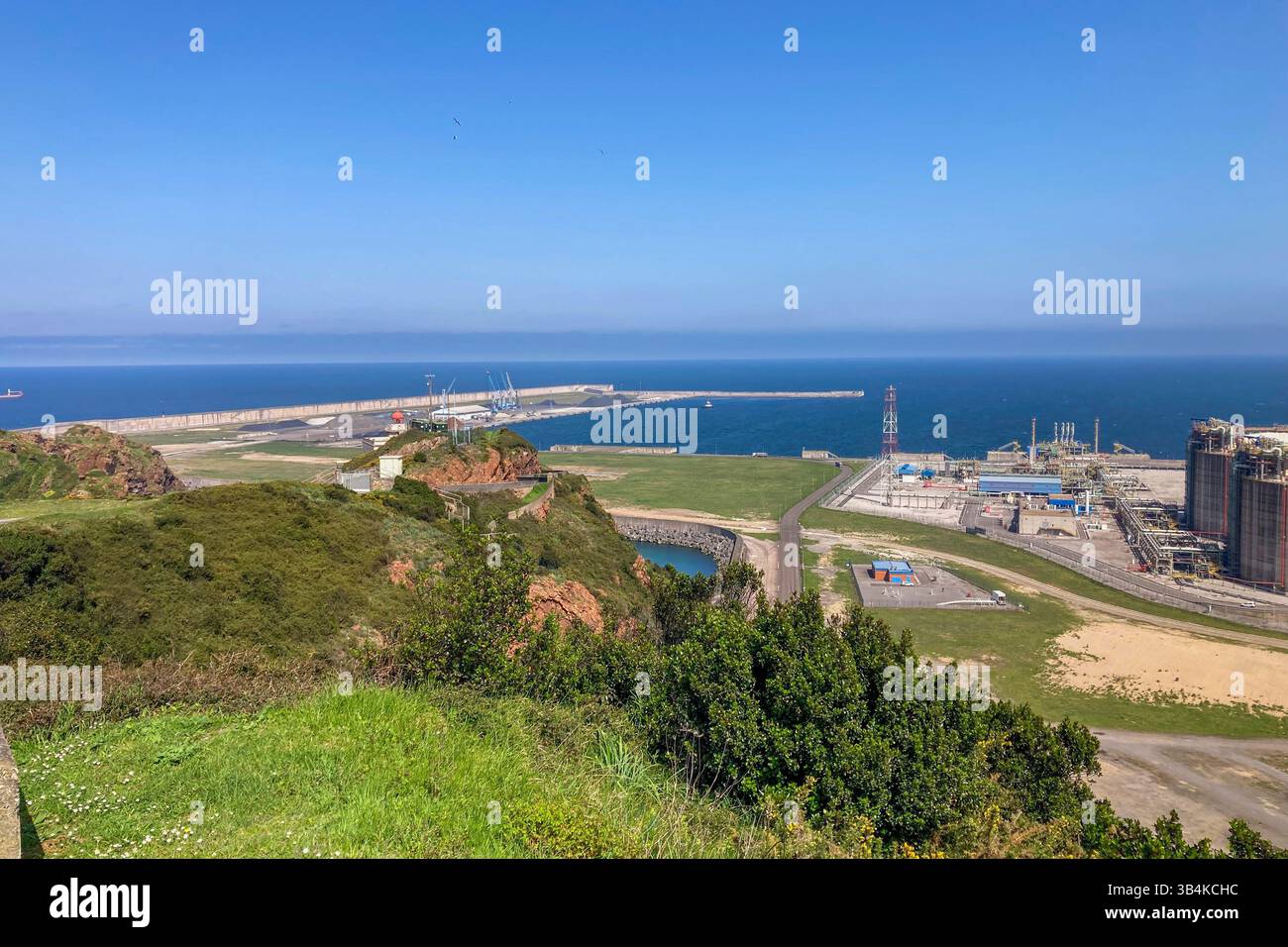 GIJON, SPAIN - APRIL  7, 2025: Gijón port settlements amidst scenic coastal landscapes in Gijón, Asturias, Spain - Smartphone Captured Stock Image