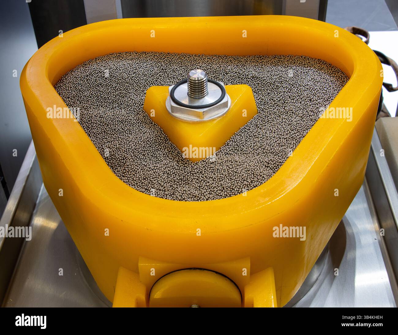 Vibratory drum surface grinding machine. Vibrating Polishing Drum for Surface Grinding and Polishing of Jewelry Accessories Stock Photo