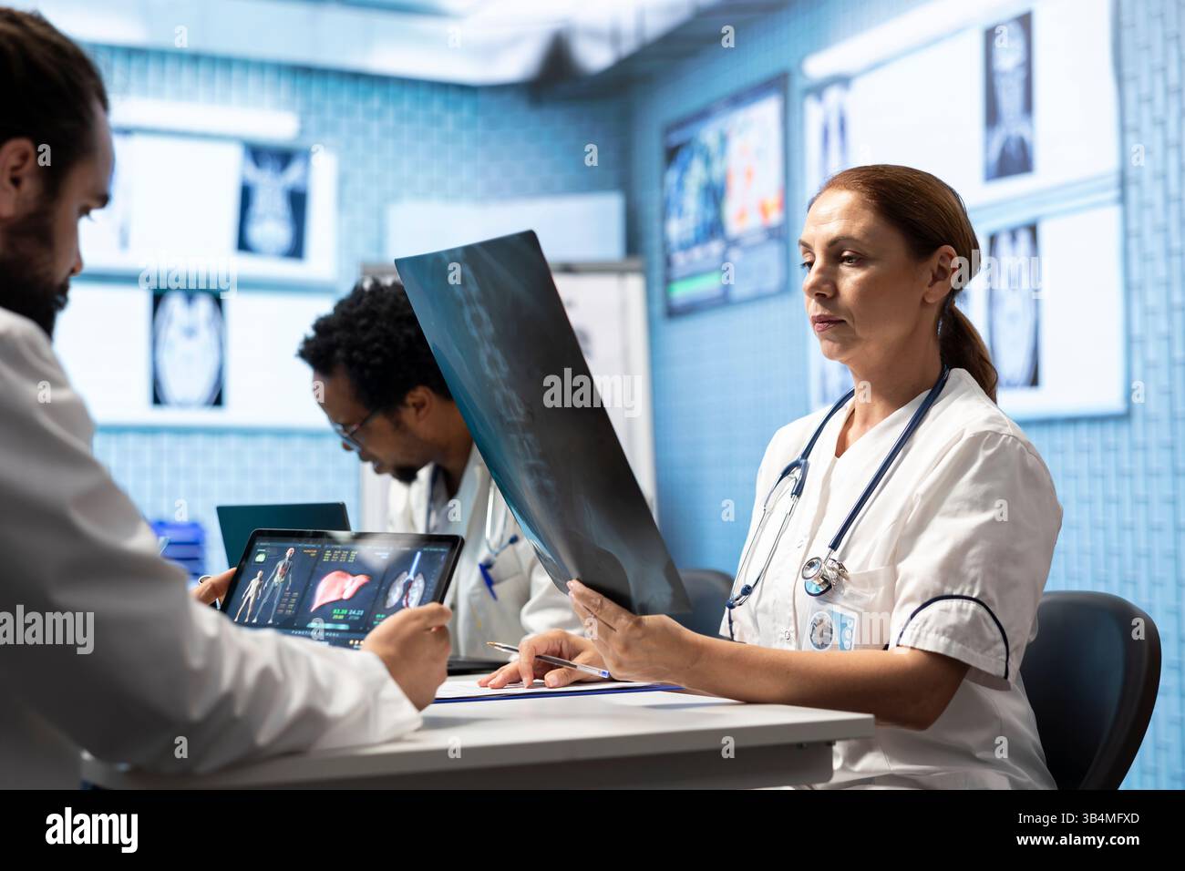 Medical experts collaborating on x ray analysis in a private clinic ...