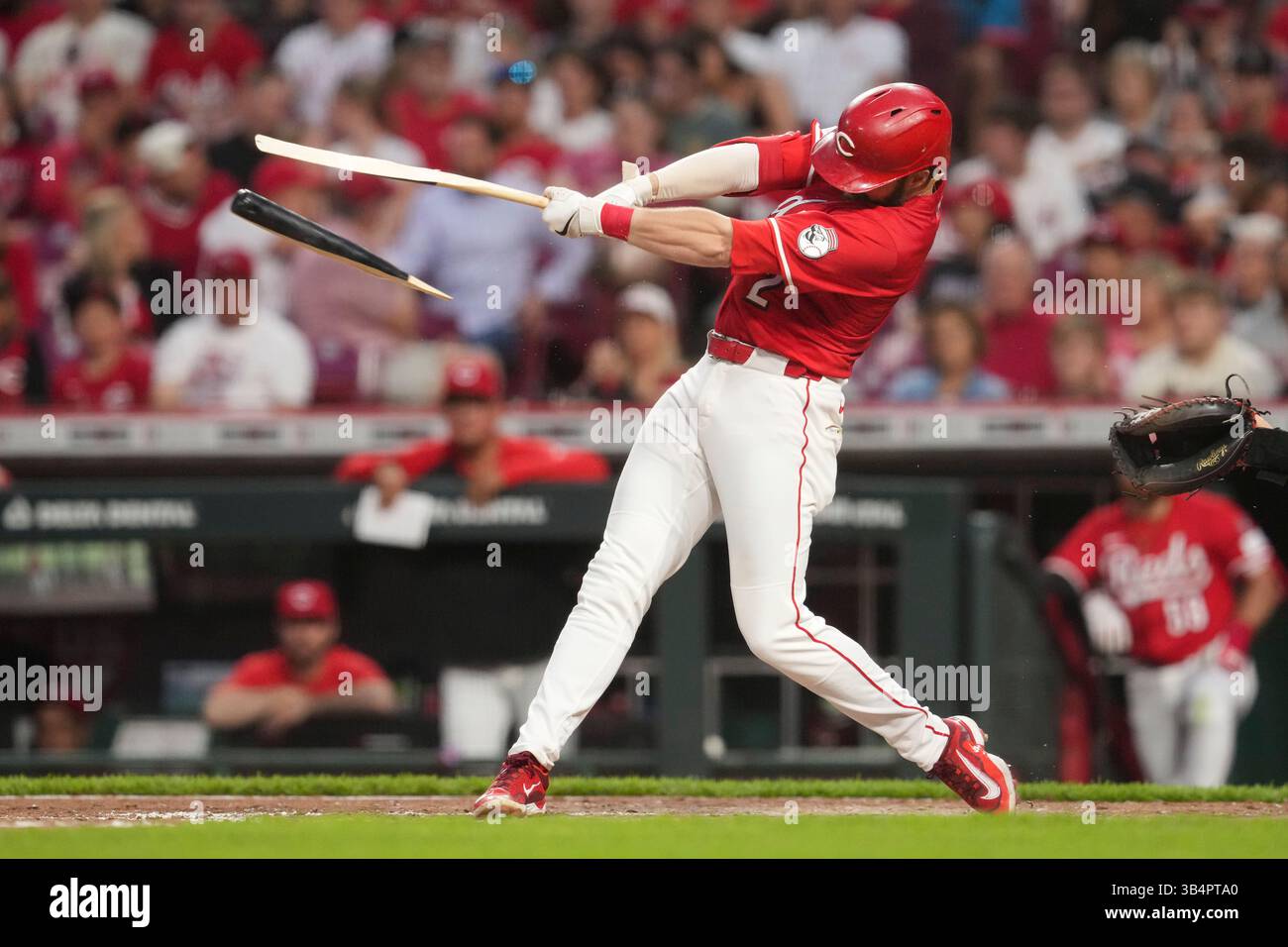 Cincinnati Reds' Gavin Lux holds onto his broken bat after grounding ...