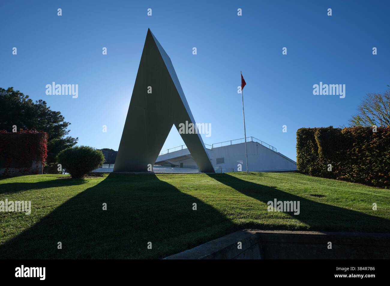 An imposing triangle shape to the exterior facade of the building. With ...