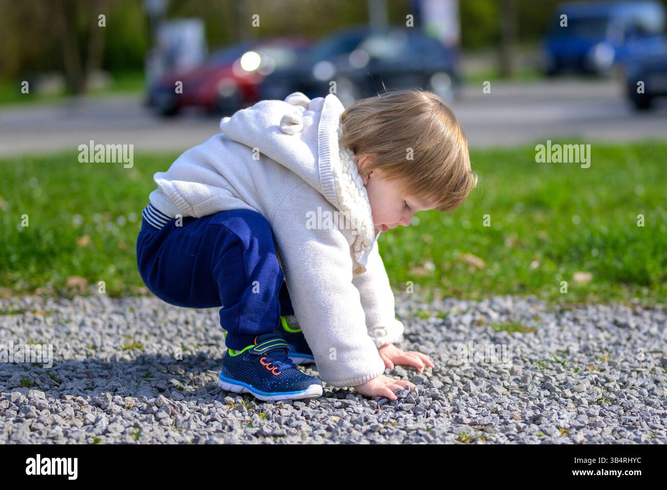 Child crouches low curious hi-res stock photography and images - Alamy