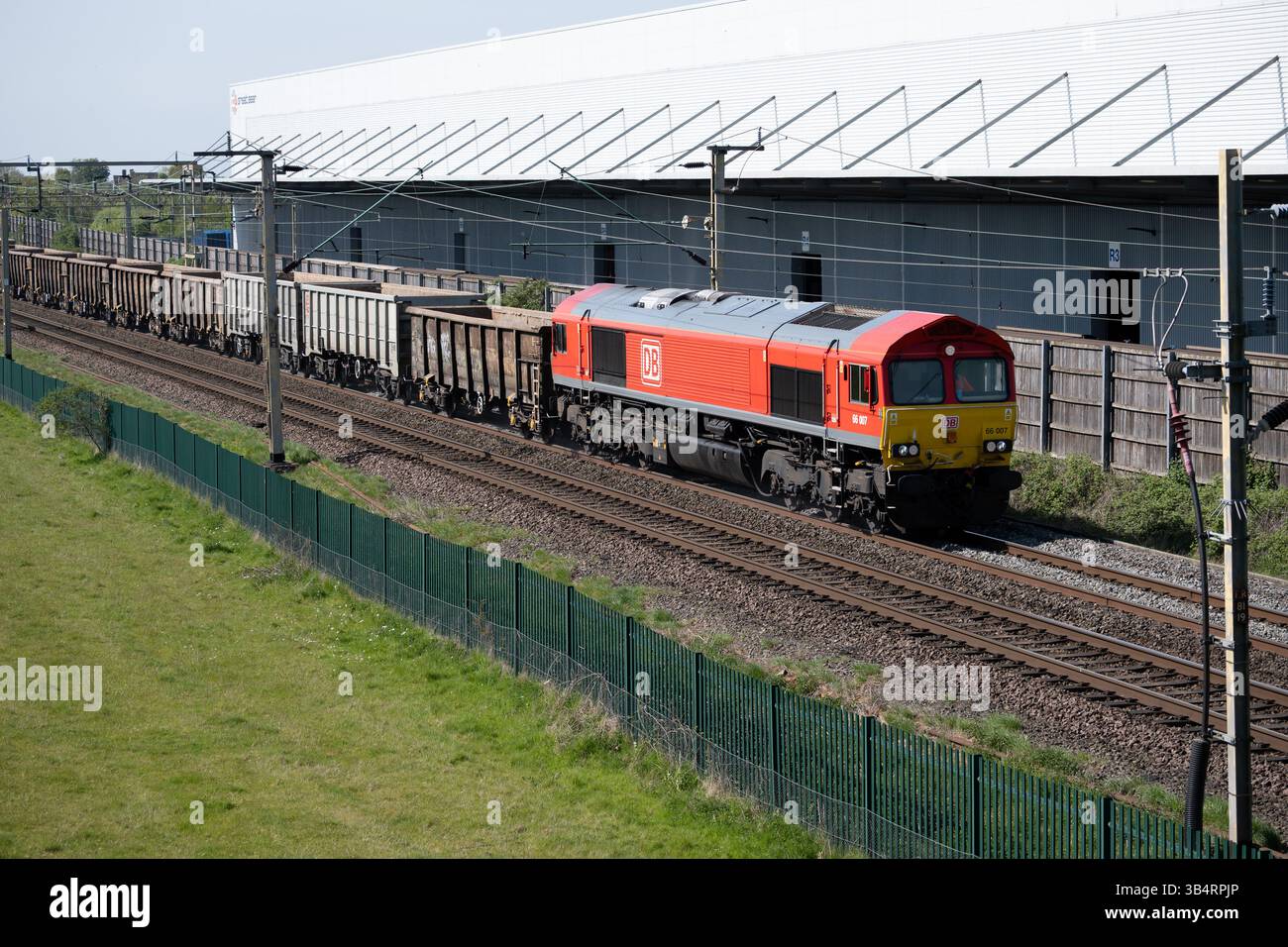 DB class 66 diesel locomotive No. 66007 pulling a freight train past ...