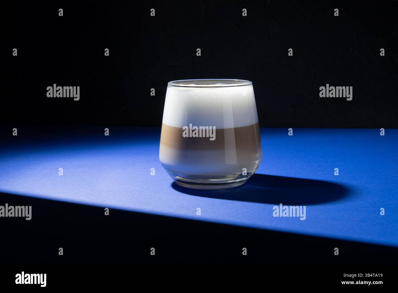 Coffee latte on a dark blue background. Studio lighting used. Stock Photo