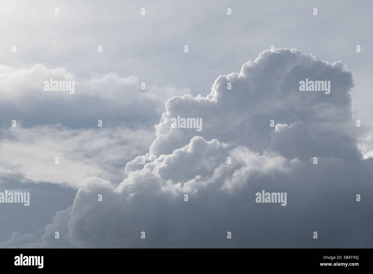 White curly clouds on a gentle blue sky. Stock Photo
