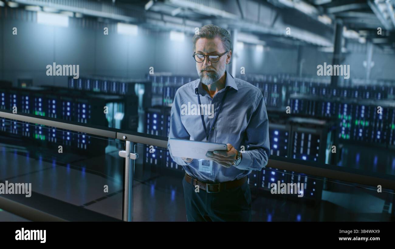 Big Data Center with Server Racks: Professional Specialist Using Tablet Computer, Activating Servers Standing In Warehouse. Information Technology Concept. Cloud Computing, Web Service. Medium Shot. Stock Photo