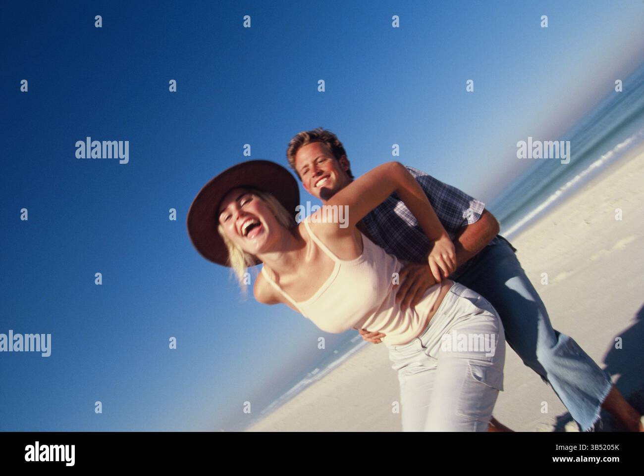 Lifestyle. Happy young couple at the beach. Stock Photo