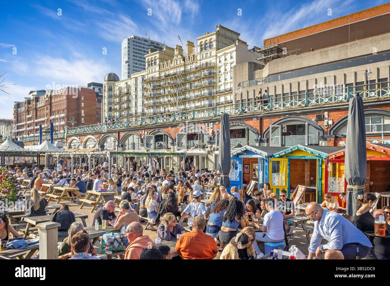 Crowded beachside cafe on Brighton beach in front of the Grand Hotel in Brighton, Sussex, UK on 27 April 2025 Stock Photo