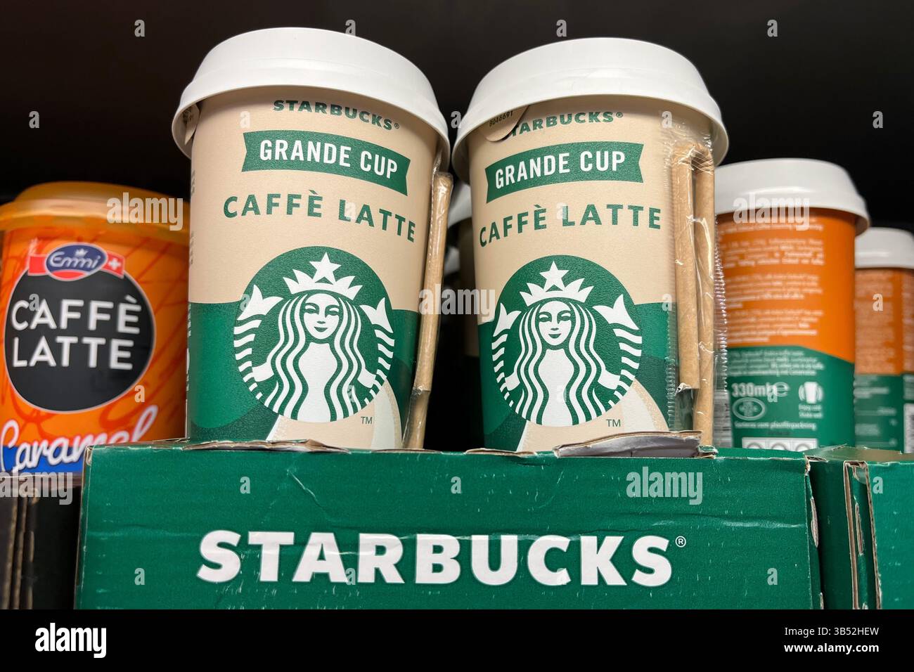 Two Starbucks Grande Cup Caffe Latte Drinks for sale on a Supermarket Shelf. 13th March 2025. - Smartphone Captured Stock Image