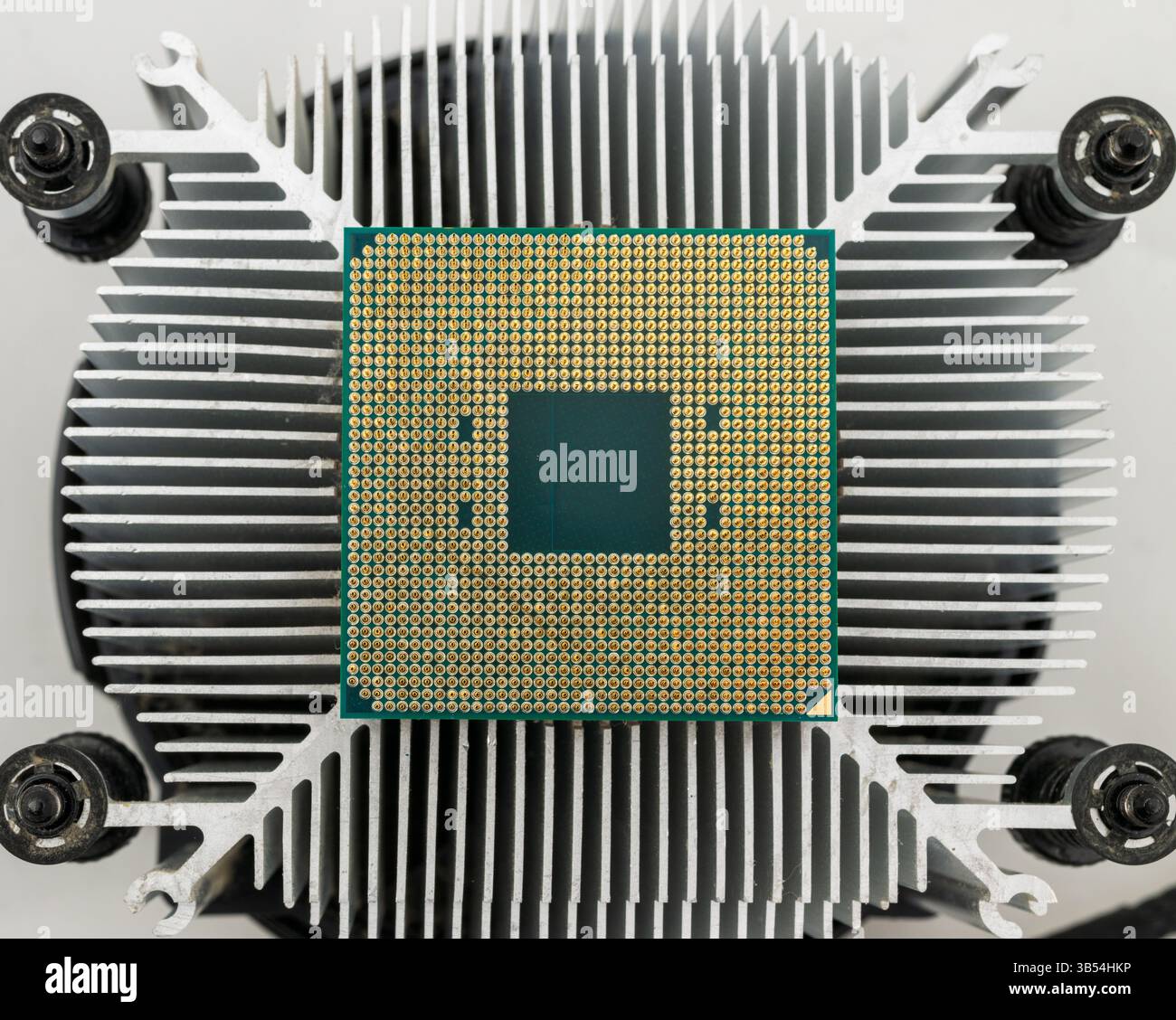 Pin side of a CPU processor mounted on a cooler Stock Photo