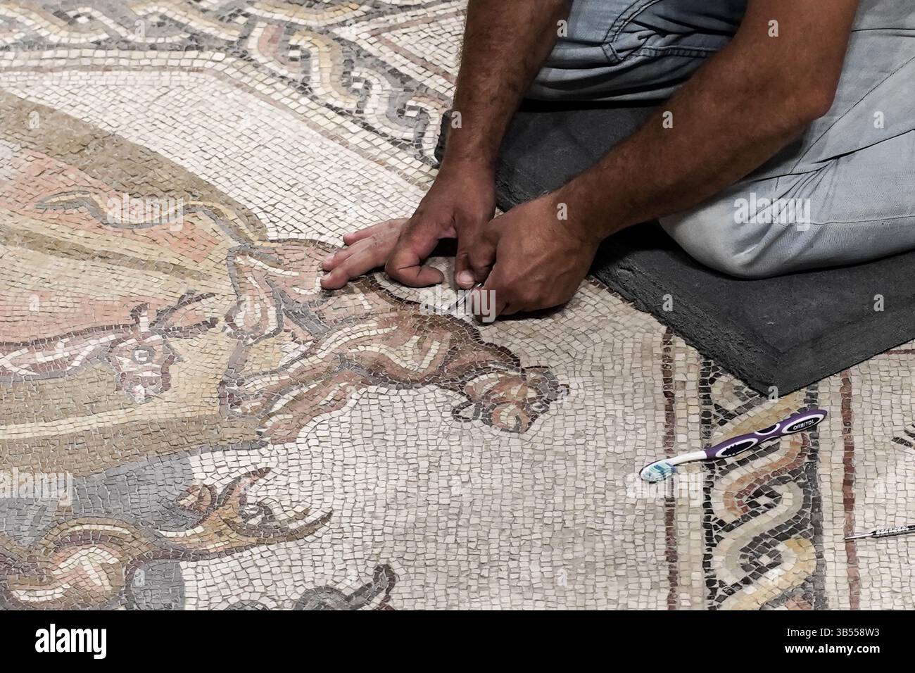 June 27, 2022, Lod, Israel: Workers conduct last minute cleanup before the Israel Antiquities Authority inaugurates the Shelby White and Leon Levy Lod Mosaic Archaeological Center. The centerâ€™s goal is to display a 1,710 square foot, Roman period (3rd to 4th century CE) mosaic which served as the floor of a living room villa in a wealthy housing complex in Lod. The mosaic, claimed by archaeologists to be extraordinary in its quality, its depicted subject matters and preservation, is being called an archaeological gem with images of mammals, birds, fish, various plants and ancient ships depic Stock Photo