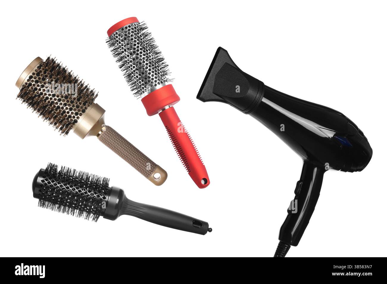 Hair dryer and round brushes in air on white background, collage Stock Photo