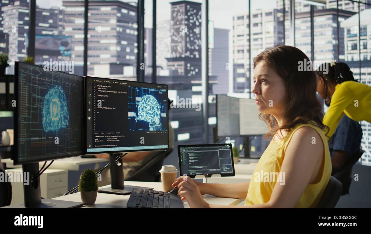 System administrator at work doing debugging of AI software using PC, checking glitches in lines of code. IT specialist in office fixing artificial intelligence coding issues using computer, camera B Stock Photo